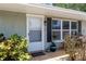 A close-up of a front entrance with vibrant plants and a charming entryway at 10827 Village Green Ave, Seminole, FL 33772