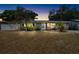 Charming home with palm trees, well-kept landscaping, and a quaint front walkway at 10827 Village Green Ave, Seminole, FL 33772