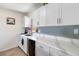 Bright kitchen featuring white cabinets, sleek countertops, and modern backsplash at 10827 Village Green Ave, Seminole, FL 33772