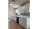 Updated kitchen with granite countertops, white cabinets, modern backsplash, and stainless steel appliances at 10827 Village Green Ave, Seminole, FL 33772