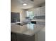 Updated kitchen with granite countertops, white cabinets, modern backsplash, and stainless steel appliances at 10827 Village Green Ave, Seminole, FL 33772
