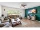 Bright living room boasting tile floors, neutral paint, and large windows at 10827 Village Green Ave, Seminole, FL 33772