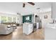 Open layout with sightlines between a modern kitchen and a comfortable living room at 10827 Village Green Ave, Seminole, FL 33772