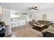 Inviting living room featuring tile floors and open layout to the kitchen at 10827 Village Green Ave, Seminole, FL 33772