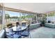 The sunroom features a glass table and chairs with a view of the garden at 10827 Village Green Ave, Seminole, FL 33772