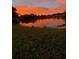 Beautiful red and orange sunset reflecting in the water at 10827 Village Green Ave, Seminole, FL 33772