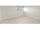 Bright bedroom featuring tiled floors, a window, and white walls at 111 Whispering Sands Cir # V38, Sarasota, FL 34242