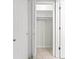 Open closet showing shelves, hanging rack, and white doors at 111 Whispering Sands Cir # V38, Sarasota, FL 34242