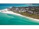 Aerial view of coastline featuring beautiful beaches, turquoise waters, and luxurious beachfront properties at 111 Whispering Sands Cir # V38, Sarasota, FL 34242