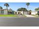 Well-maintained single-story home with an attached garage and mature landscaping at 111 Whispering Sands Cir # V38, Sarasota, FL 34242