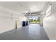 Spacious garage with white walls, painted floor, and an open garage door at 111 Whispering Sands Cir # V38, Sarasota, FL 34242