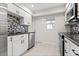 Modern kitchen with stainless appliances, granite counters, and stylish backsplash at 111 Whispering Sands Cir # V38, Sarasota, FL 34242