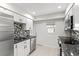 Modern kitchen with stainless appliances, granite counters, and stylish backsplash at 111 Whispering Sands Cir # V38, Sarasota, FL 34242