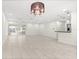 Spacious living room with tiled floors, a chandelier, recessed lighting, and sliding doors at 111 Whispering Sands Cir # V38, Sarasota, FL 34242