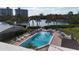 An overhead view of the stunning community pool surrounded by palm trees at 111 Whispering Sands Cir # V38, Sarasota, FL 34242