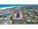 An aerial view shows these condos feature beach proximity, tennis courts, and a pond at 1159 Lake House Cir # C120, Sarasota, FL 34242