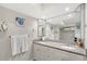 Bathroom features a double-sink vanity with granite countertops, decorative mirrors and a walk-in closet at 1159 Lake House Cir # C120, Sarasota, FL 34242