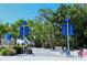 Beach access with Siesta Beach signage, trees, bike racks, benches, and a paved walkway at 1159 Lake House Cir # C120, Sarasota, FL 34242