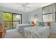 Bright bedroom features two beds, balcony access, and ample natural light at 1159 Lake House Cir # C120, Sarasota, FL 34242