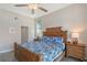 Comfortable bedroom features a woven headboard, a ceiling fan, and natural light from the windows at 1159 Lake House Cir # C120, Sarasota, FL 34242