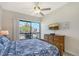 This charming bedroom features a woven headboard, ceiling fan and access to a private balcony at 1159 Lake House Cir # C120, Sarasota, FL 34242