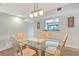Inviting dining area with table seating four and natural lighting at 1159 Lake House Cir # C120, Sarasota, FL 34242