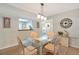 Dining room with seating for four, decorative clock, and views to kitchen at 1159 Lake House Cir # C120, Sarasota, FL 34242