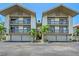 A well maintained condominium exterior shows covered parking and balconies with tropical plants adding to the landscape at 1159 Lake House Cir # C120, Sarasota, FL 34242