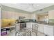 Bright kitchen features white cabinetry, a tile floor, modern appliances and a dining area at 1159 Lake House Cir # C120, Sarasota, FL 34242