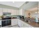 This well-lit kitchen showcases white cabinets, modern appliances, and a convenient serving hatch at 1159 Lake House Cir # C120, Sarasota, FL 34242