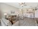 Bright living room with gray flooring, comfortable seating, and an open floor plan at 1159 Lake House Cir # C120, Sarasota, FL 34242