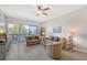 Bright living room featuring comfortable seating, wood-look floors, and access to the balcony at 1159 Lake House Cir # C120, Sarasota, FL 34242