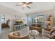 Inviting living room with wood-look floors and a view of the balcony at 1159 Lake House Cir # C120, Sarasota, FL 34242