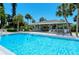 Sparkling community swimming pool with covered pavilion for relaxation and shade at 1159 Lake House Cir # C120, Sarasota, FL 34242