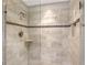 Modern shower featuring neutral tile, decorative accent tiles, built-in shelf and glass doors at 1159 Lake House Cir # C120, Sarasota, FL 34242