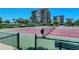 Well-maintained tennis court with an enclosed fence and nearby seating within the community at 1159 Lake House Cir # C120, Sarasota, FL 34242