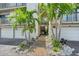 Attractive condo entrance featuring a garden path and individual garages at 1159 Lake House Cir # C120, Sarasota, FL 34242