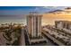 Stunning beachfront high-rise condo with private parking, manicured landscaping, and beautiful ocean views at sunset at 1212 Benjamin Franklin Dr # 909, Sarasota, FL 34236