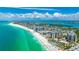 Scenic aerial view showcasing the condominium building with beach access and ocean views at 1212 Benjamin Franklin Dr # 909, Sarasota, FL 34236