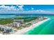Amazing aerial view of the beachfront condominium complex surrounded by turquoise waters at 1212 Benjamin Franklin Dr # 909, Sarasota, FL 34236