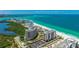 Stunning aerial view of the condominium building near the beach and ocean at 1212 Benjamin Franklin Dr # 909, Sarasota, FL 34236