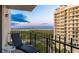 Enjoy a serene sunset from this balcony with views of the water and city skyline at 1212 Benjamin Franklin Dr # 909, Sarasota, FL 34236
