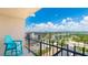 Balcony with a bright blue Adirondack chair offering city and bay views at 1212 Benjamin Franklin Dr # 909, Sarasota, FL 34236