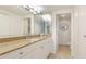 Bathroom featuring granite countertops, ample lighting, and access to a connected toilet area at 1212 Benjamin Franklin Dr # 909, Sarasota, FL 34236
