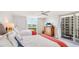 Bedroom with two beds and access to balcony with ocean view at 1212 Benjamin Franklin Dr # 909, Sarasota, FL 34236