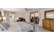 Bright bedroom featuring a desk, ceiling fan, and sliding glass doors to a balcony at 1212 Benjamin Franklin Dr # 909, Sarasota, FL 34236
