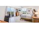 Inviting bedroom with balcony access, water views, and coastal-themed decor, creating a relaxing retreat at 1212 Benjamin Franklin Dr # 909, Sarasota, FL 34236