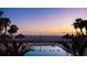 Relaxing community pool featuring a tranquil ocean view and inviting tiki umbrellas at 1212 Benjamin Franklin Dr # 909, Sarasota, FL 34236