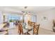 Elegant dining room with glass table, seating for six, and mirrored wall reflecting stunning views at 1212 Benjamin Franklin Dr # 909, Sarasota, FL 34236