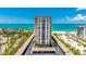 Striking exterior shot of the condominium building, showcasing beach access and coastal views at 1212 Benjamin Franklin Dr # 909, Sarasota, FL 34236